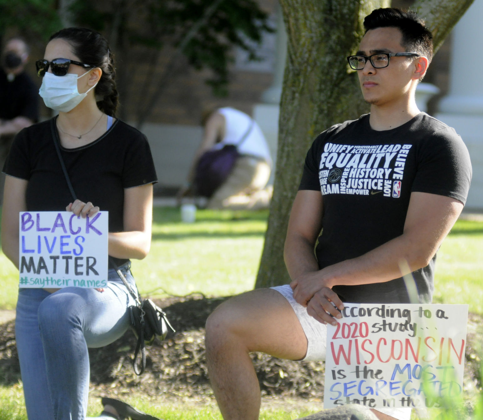 Demonstrators kneel